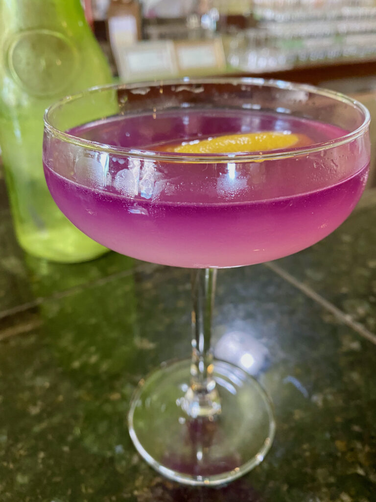 Purple gradient martini with a slice of lemon